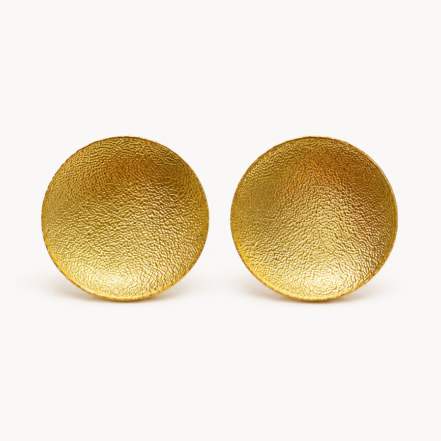 Gold brass textured disc stud earrings on white background