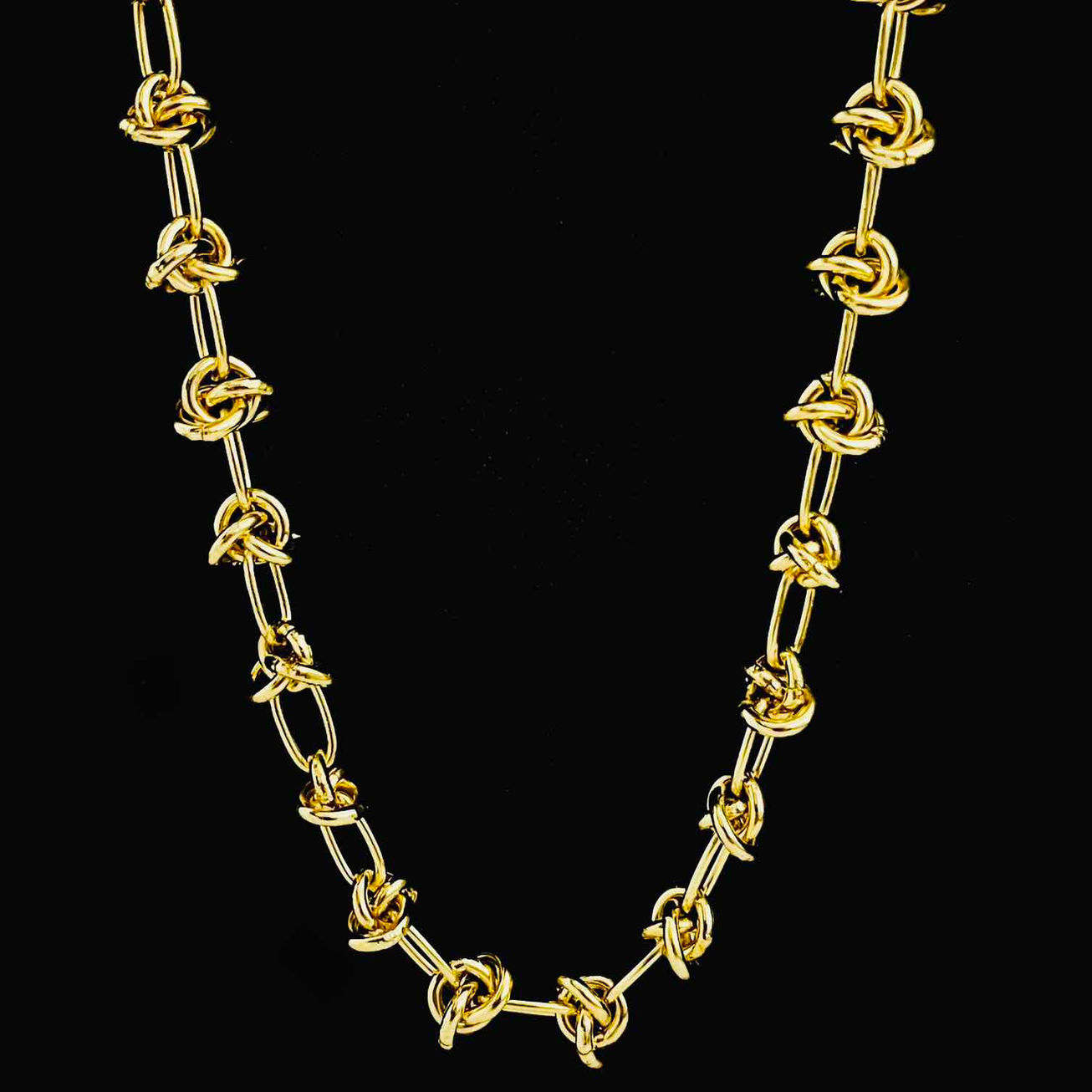 A stunning 18K gold-plated knot-link chain necklace, featuring a series of intertwined golden links with a glossy finish, lai