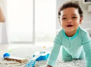 Smiling baby at home, symbolizing safe in-home circumcision services.