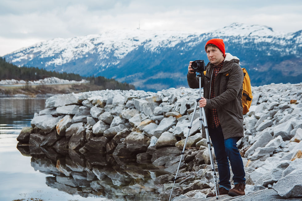 traveler-man-takes-pictures-shooting-camera-tripod-background-mountains-lakes.jpg