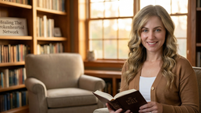 Professional portrait of Nicole Pearson, a Christian Counselor and Psychotherapist, sitting in a warm office holding a Bible with a "Healing The Brokenhearted Network" sign in the background.