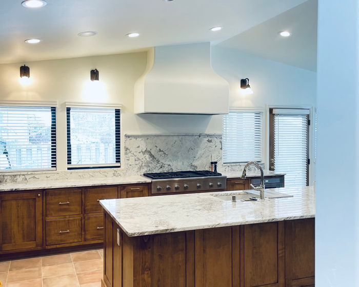 Faux wood blinds with cornices in a kitchen