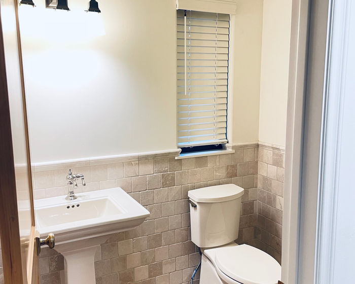 Faux wood blind with a cornice in a powder bath