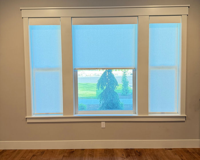 Light-filtering roller shades on a triple window