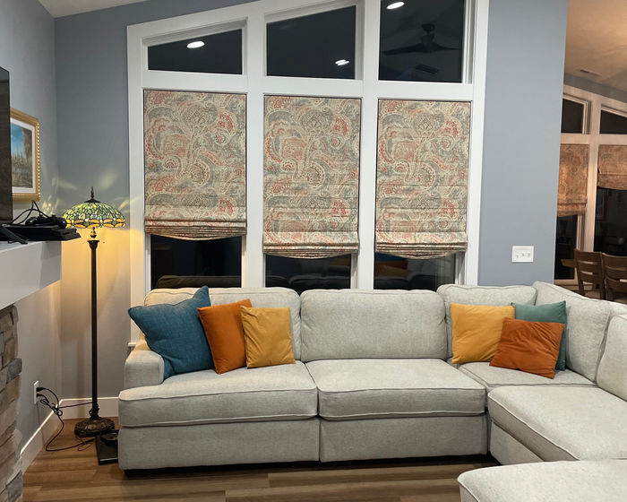 Patterned Roman shades in a family room