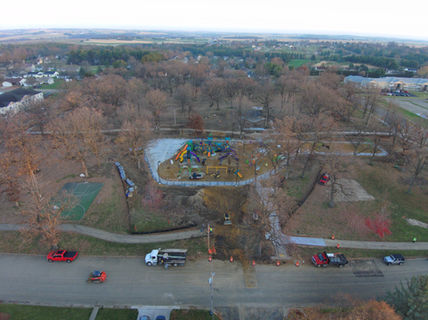 Aerial view of park with buildings and trees; Vector Drone Service.