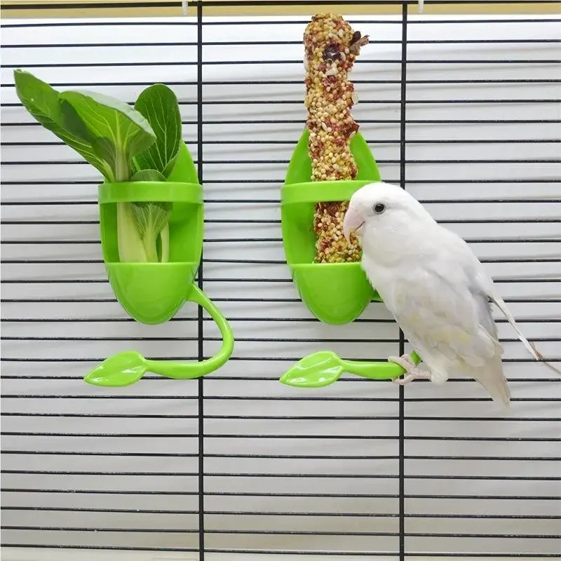 Small white bird on a green leaf-shaped bird cuttlebone holder