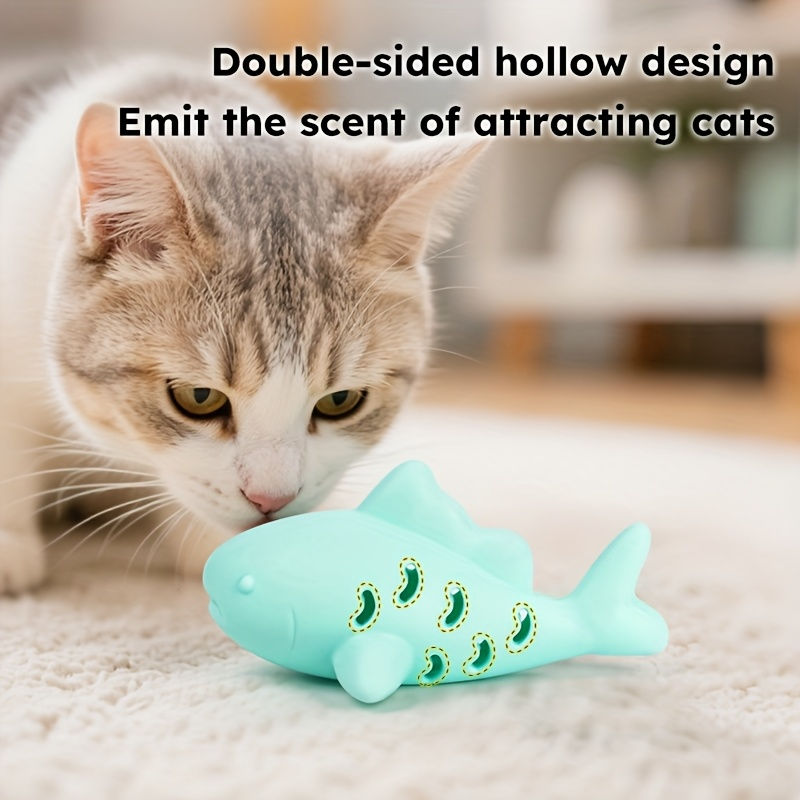 Thumbnail: Cat sniffing fish-shaped toy with double-sided hollow design