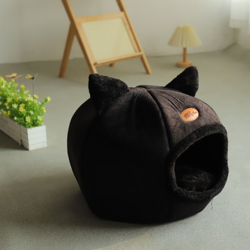 Thumbnail: Small black deep sleep cat bed with ears on a floor