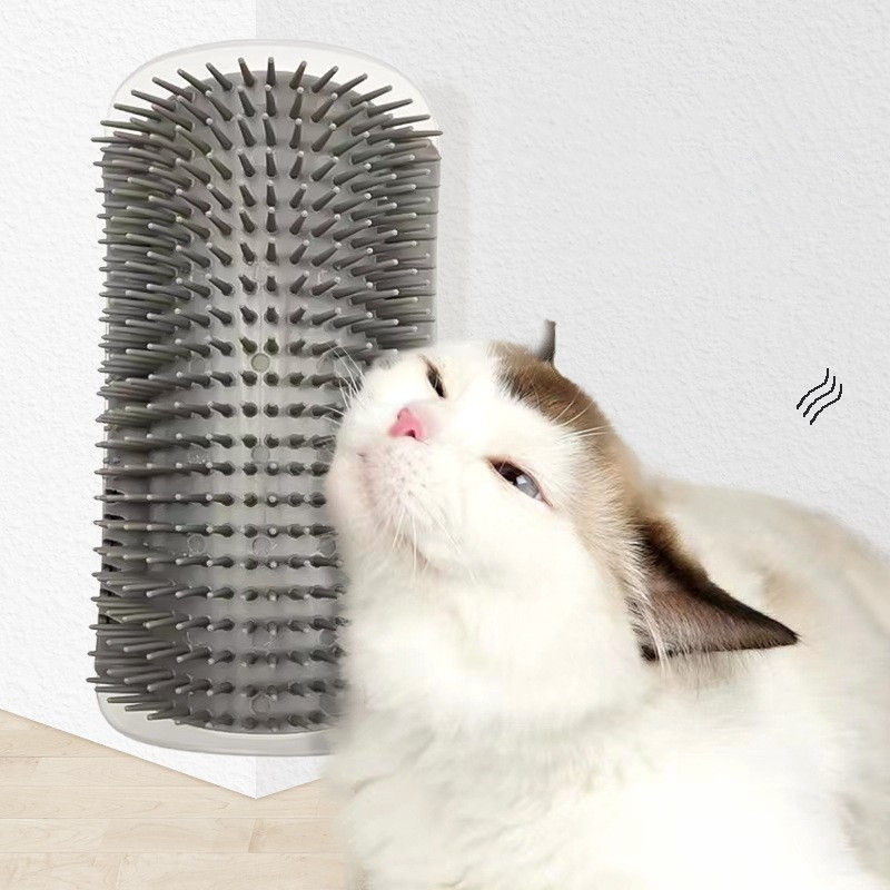 Cat rubbing face on wall-mounted corner groomer brush