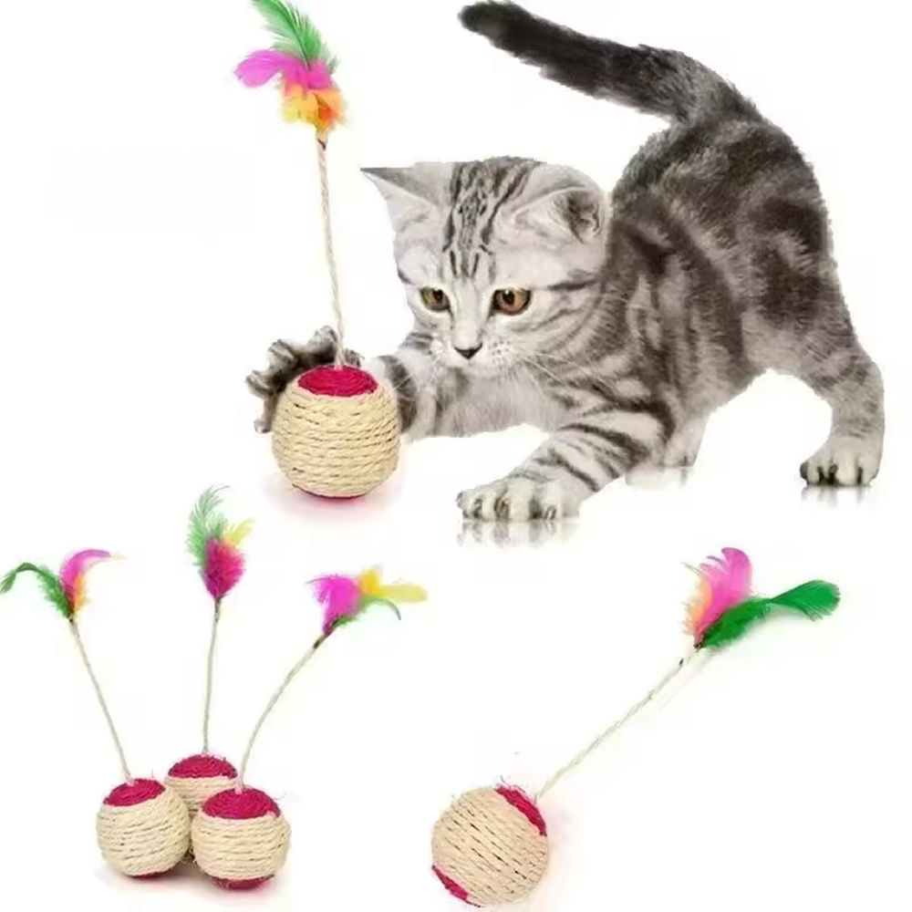 Grey kitten playing with a sisal cat scratching ball with feather.
