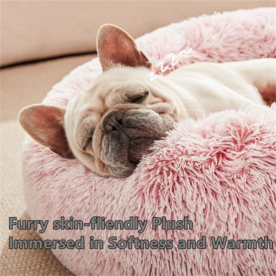French bulldog sleeping in a plush pink donut round bed