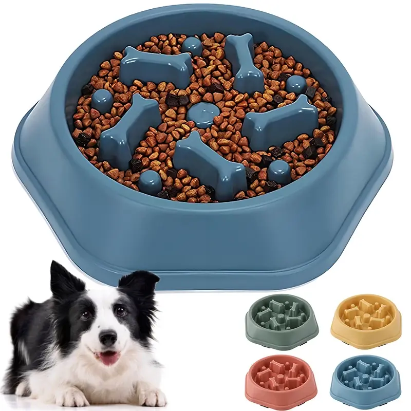 Blue anti-gulping maze pet food bowl with kibble and dog.