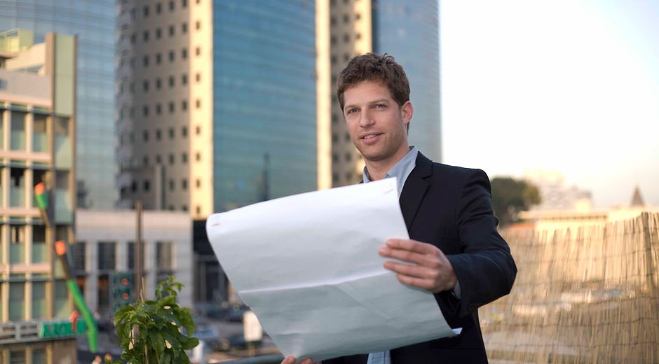 Man Holding Blueprint