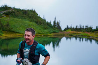 Runner moving through forested trail during the HahNicNaAah race near Smithers, BC
