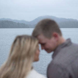 couples photos on a lake with mountains
