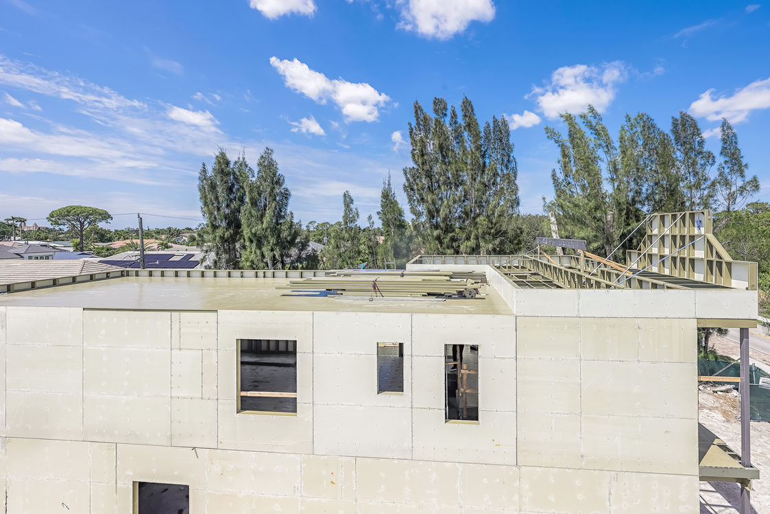 Building under construction with a blue sky in the background.