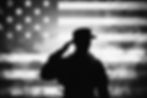 Silhouette of soldier saluting against US flag, honoring service and sacrifice.