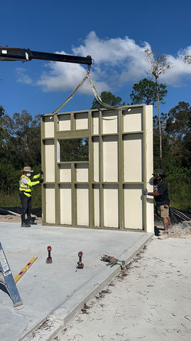 Workers installing a curtain wall panel for Northstar Building Systems.