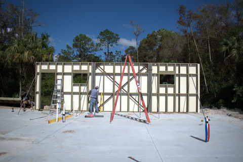 Construction worker installing wall panels
