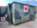 Camouflaged mobile medical unit with red cross