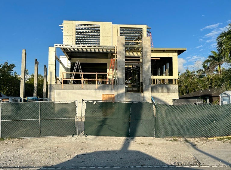 Exterior view of a modern house under construction on a sunny day
