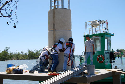 Workers installing the Hamilton Harbor Lighthouse structure.