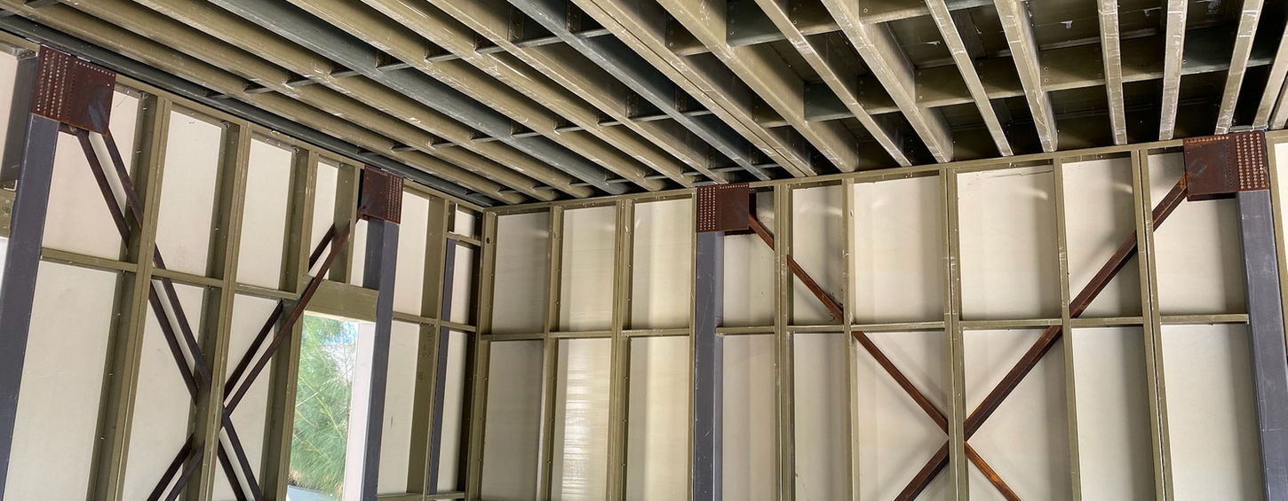 Interior of a building under construction showing metal beams and support structures.