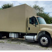 Beige box truck parked outdoors