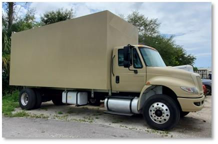 Beige box truck parked outdoors