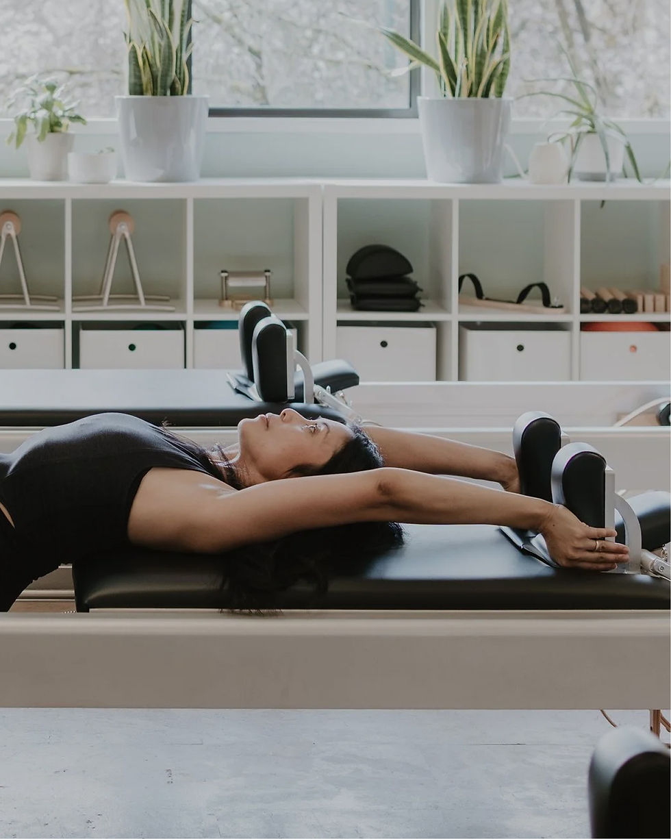 Marcia Rosales practicing Pilates on a reformer