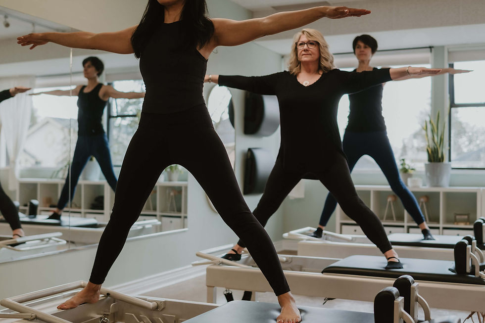 Students practicing Pilates together at Canvas Pilates studio