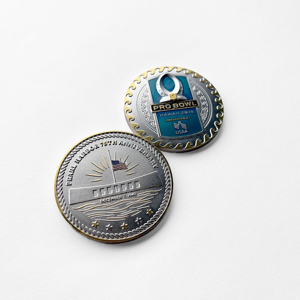 Two-sided commemorative coin shown. One side features the 2016 NFL Pro Bowl in Hawaii with bold blue and silver enamel and Polynesian motifs. The other side depicts the USS Arizona Memorial for the 75th anniversary of Pearl Harbor with stars, waves, and a rising sun motif.