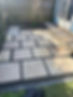 Modern garden patio featuring grey stone pavers and dark gravel borders
