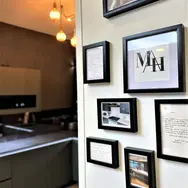 Modern kitchen wall display with framed artwork and cabinetry