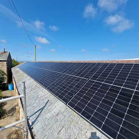 Solar panels on a sloped roof under a clear blue sky