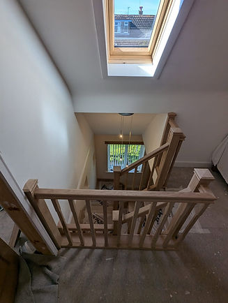 Top view of a bespoke wooden staircase with glass handrails