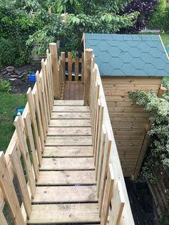 Raised wooden gangway bridge designed for a children play structure