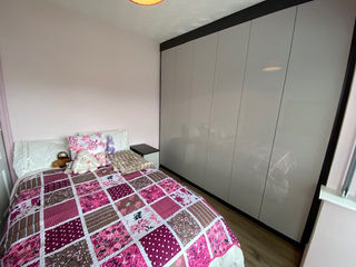 Fitted sliding door wardrobe in modern neutral bedroom