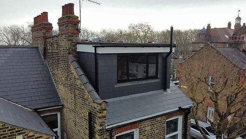 Modern rooftop dormer extension on a brick house