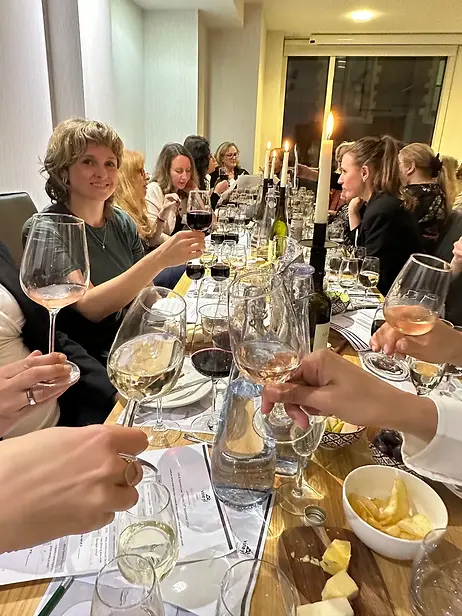 Guests seated around a table enjoying wine and conversation
