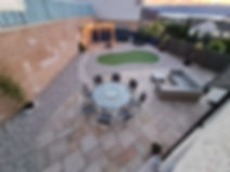 Large garden with small golf green and patio