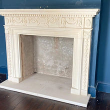 Ornate limestone fireplace with intricate carvings