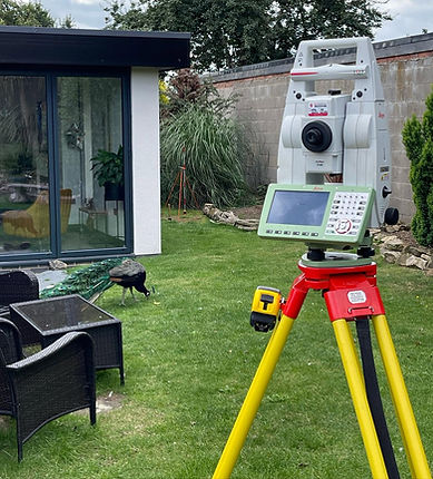 Leica total station surveying unit positioned on grassy ground