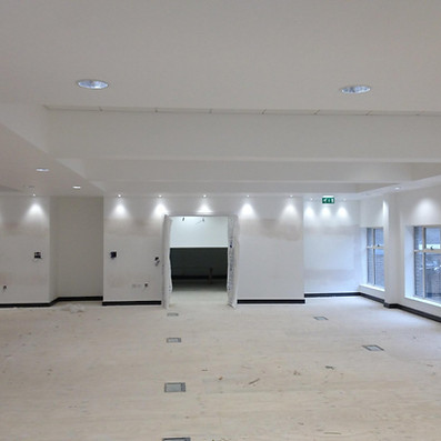 Large empty commercial room with freshly installed dry lining walls
