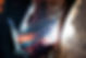 A professional welder in a protective mask and heavy-duty gloves working on a metal pipe with bright sparks and smoke