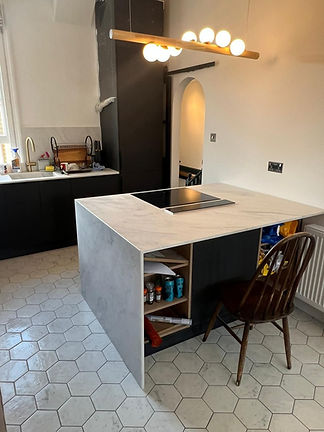 Modern kitchen island with marble-effect worktop and integrated induction hob
