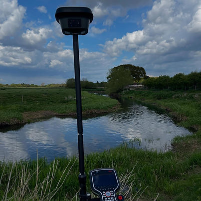 Surveying prism rod and controller device positioned beside natural stream