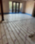 Wide view of a professional underfloor heating pipework installation across a large residential floor
