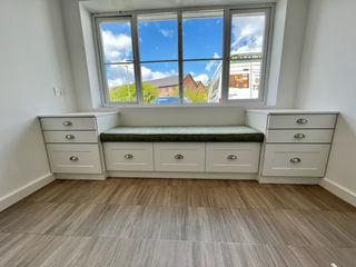 Built-in window seat with fitted storage drawers underneath